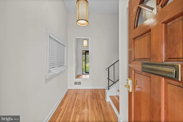 a view of a livingroom with wooden floor and stairs