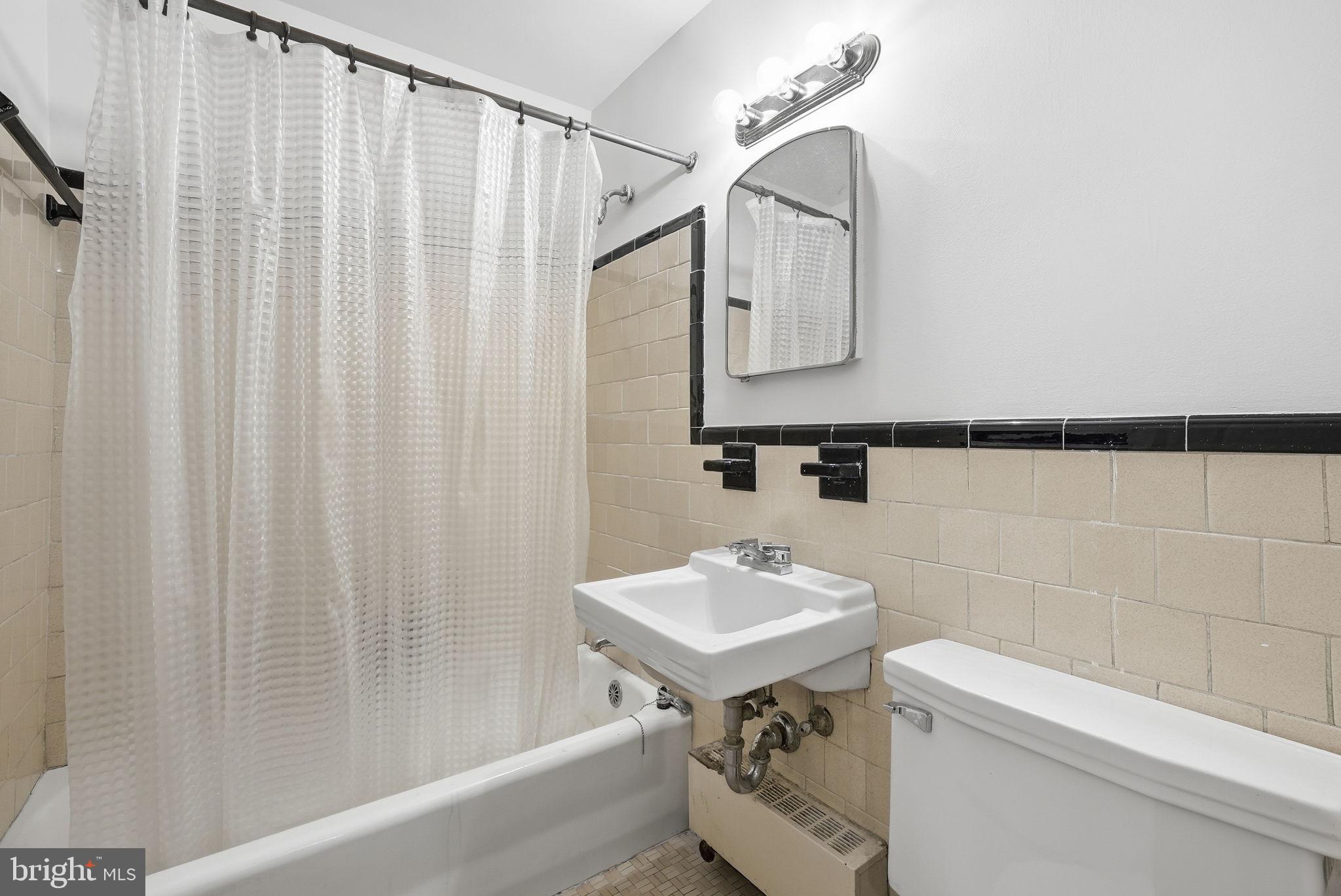 4100 W Street Northwest, Unit 203 Washington, DC 20007 - Photo 11 of 18 a bathroom with a sink a toilet and shower