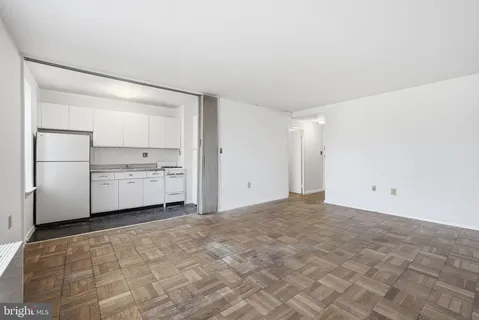 a view of cabinets and refrigerator