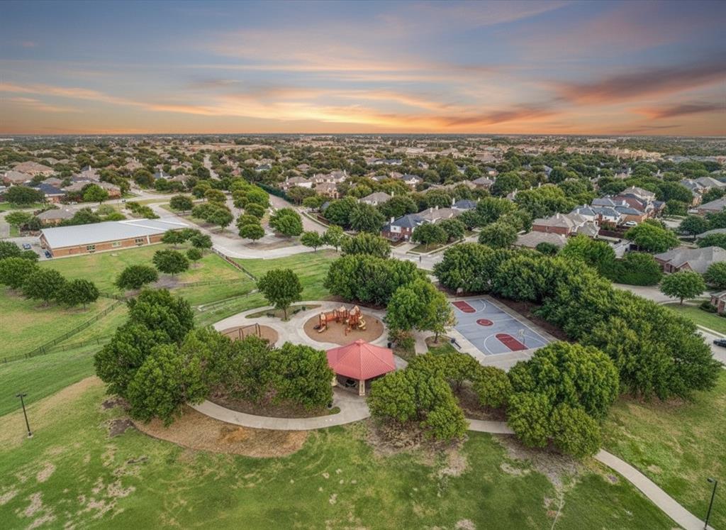 1699 Garrison Drive Frisco, TX 75033 - Photo 25 of 27 Expansive park area featuring a playground, basketball court, and covered pavilion, surrounded by mature trees
