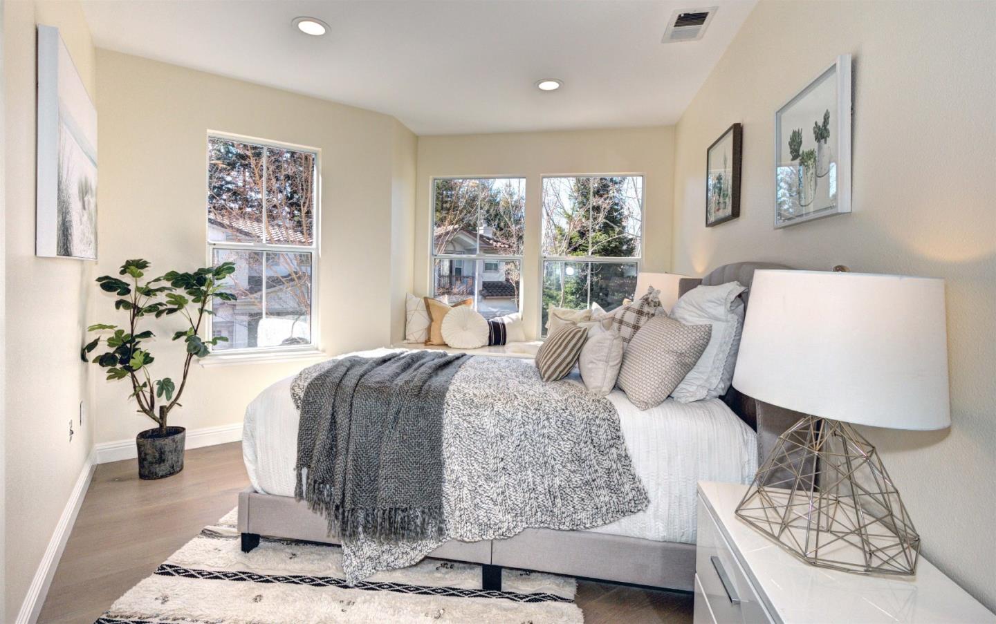 10197 Macadam Lane Cupertino, CA 95014 - Photo 17 of 28 a bedroom with a large bed and a potted plant