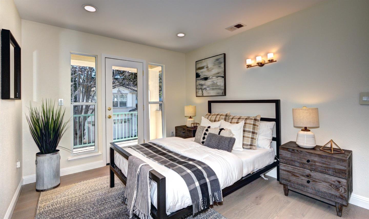 10197 Macadam Lane Cupertino, CA 95014 - Photo 19 of 28 a bedroom with a bed and a potted plant