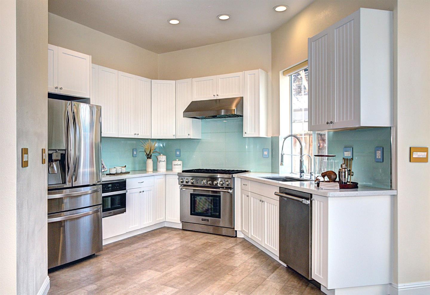 10197 Macadam Lane Cupertino, CA 95014 - Photo 7 of 28 a kitchen with stainless steel appliances granite countertop a stove a refrigerator and a sink