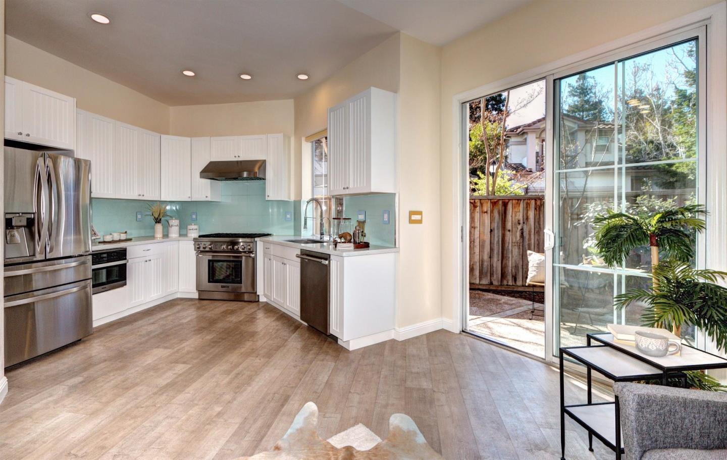 10197 Macadam Lane Cupertino, CA 95014 - Photo 8 of 28 a kitchen with a sink a counter top space stainless steel appliances and a window