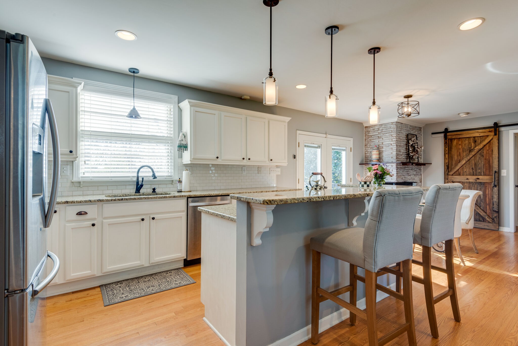 4902 Timberhill Drive Nashville, TN 37211 - Photo 9 of 30 a kitchen with stainless steel appliances granite countertop a sink a stove a refrigerator white cabinets with wooden floor