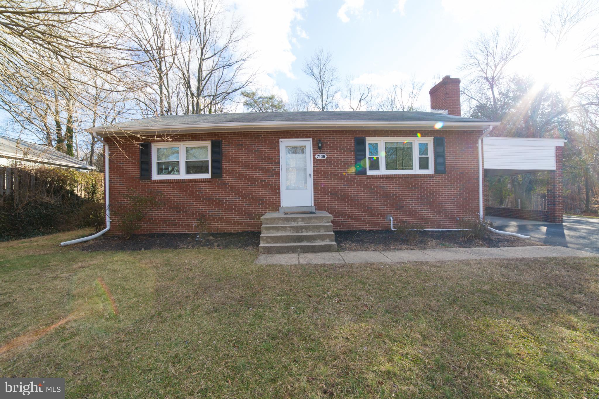 7106 Calamo Street Springfield, VA 22150 - Photo 1 of 30 a front view of a house with a yard and garage