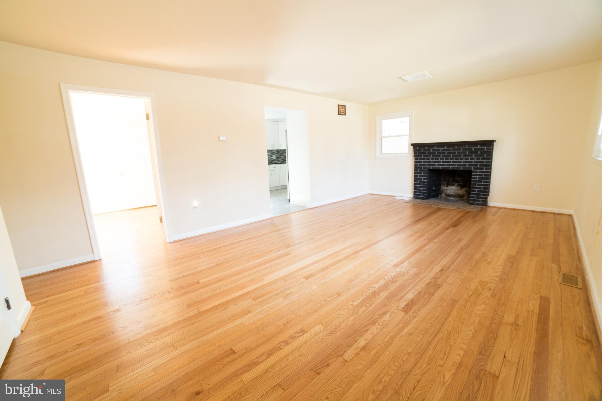 7106 Calamo Street Springfield, VA 22150 - Photo 3 of 30 a view of an empty room with wooden floor