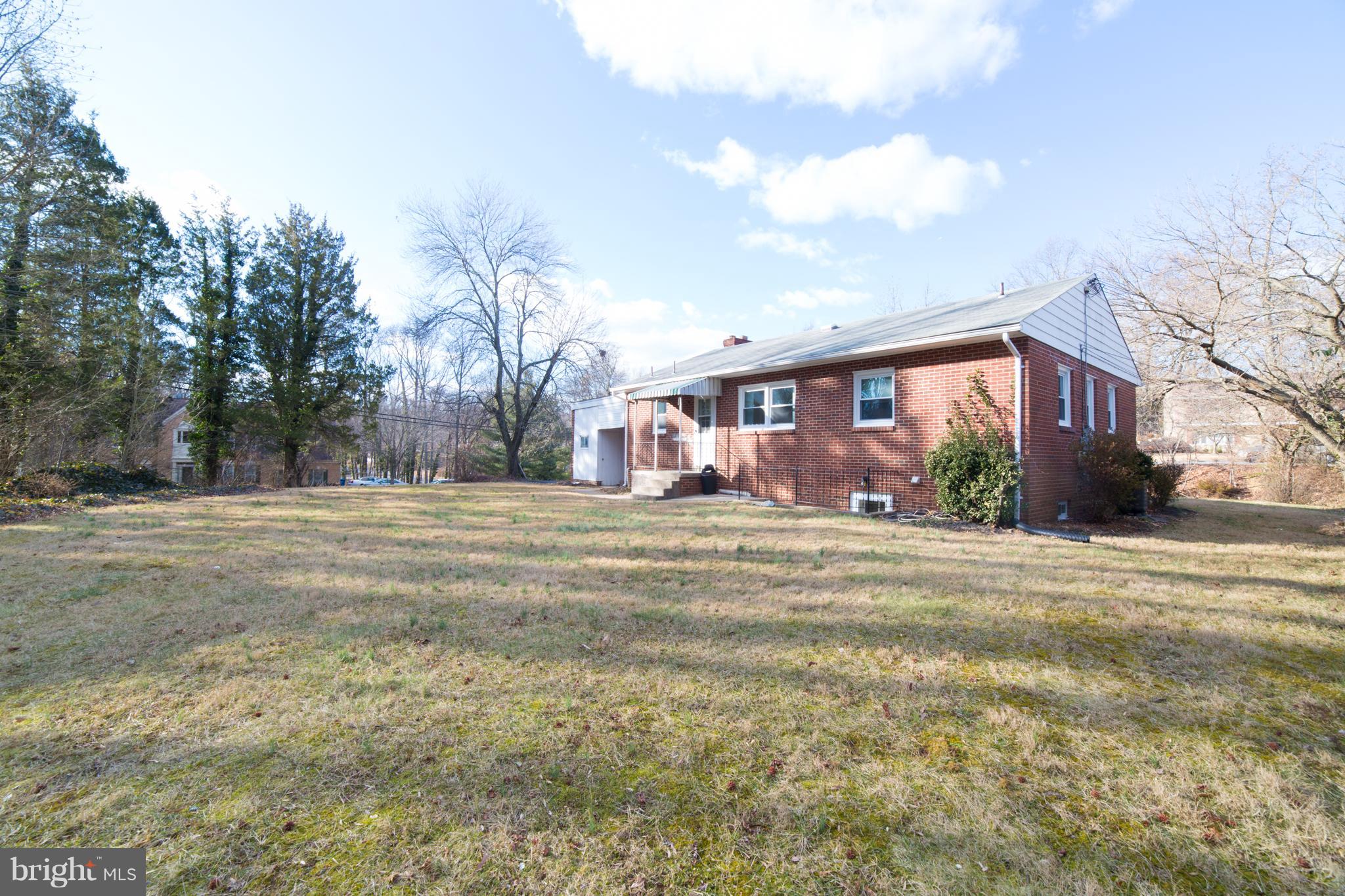 7106 Calamo Street Springfield, VA 22150 - Photo 29 of 30 a front view of house with yard and trees in the background
