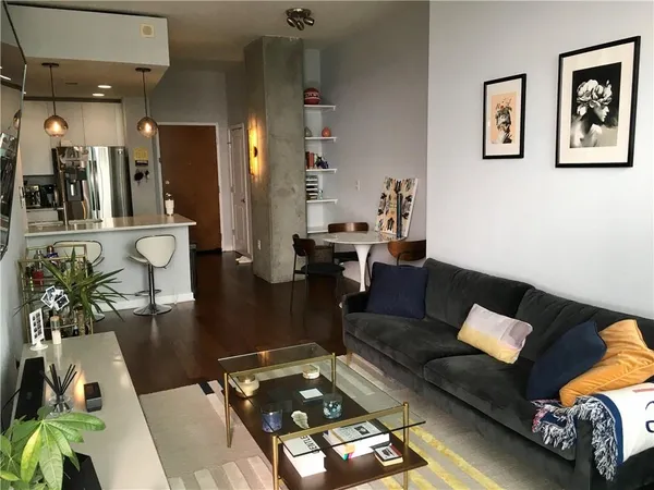 a living room with furniture and wooden floor