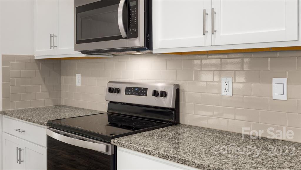 356 Gaines Road Clover, SC 29710 - Photo 8 of 48 a kitchen with granite countertop white cabinets and a stove