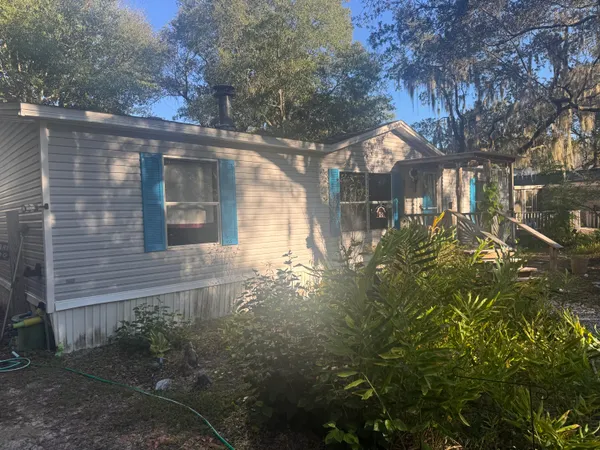 a yellow house with trees in front of it