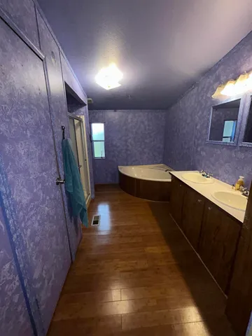 a bathroom with double vanity and a sink