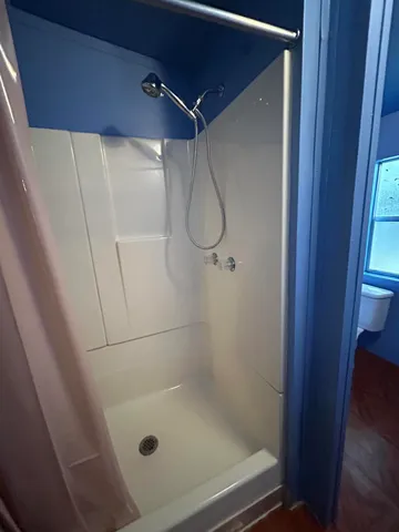 a bathroom with a glass shower door
