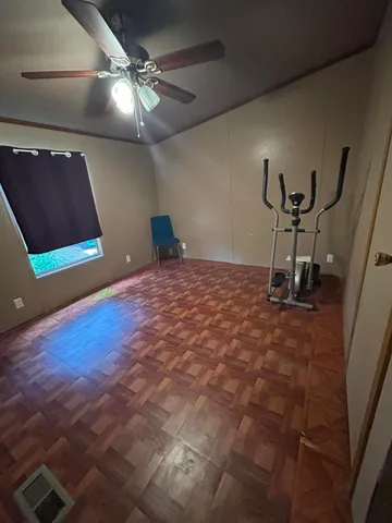 a room with gym equipment and a flat screen tv
