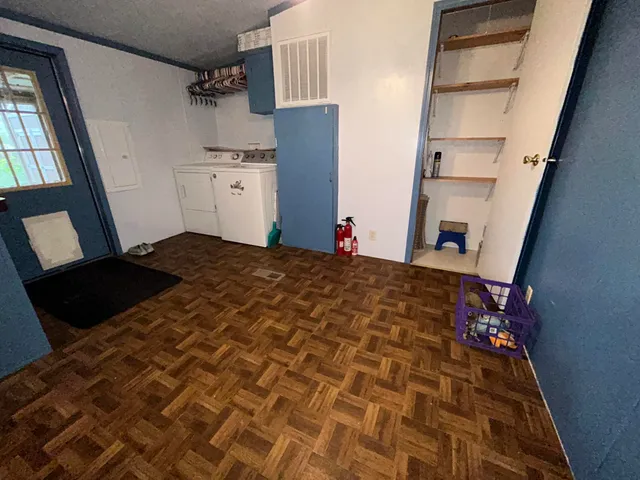 a bed sitting in a kitchen next to a window