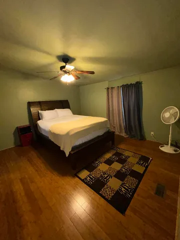 a bedroom with bed and a chandelier