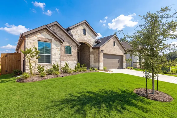 a front view of house with yard and green space
