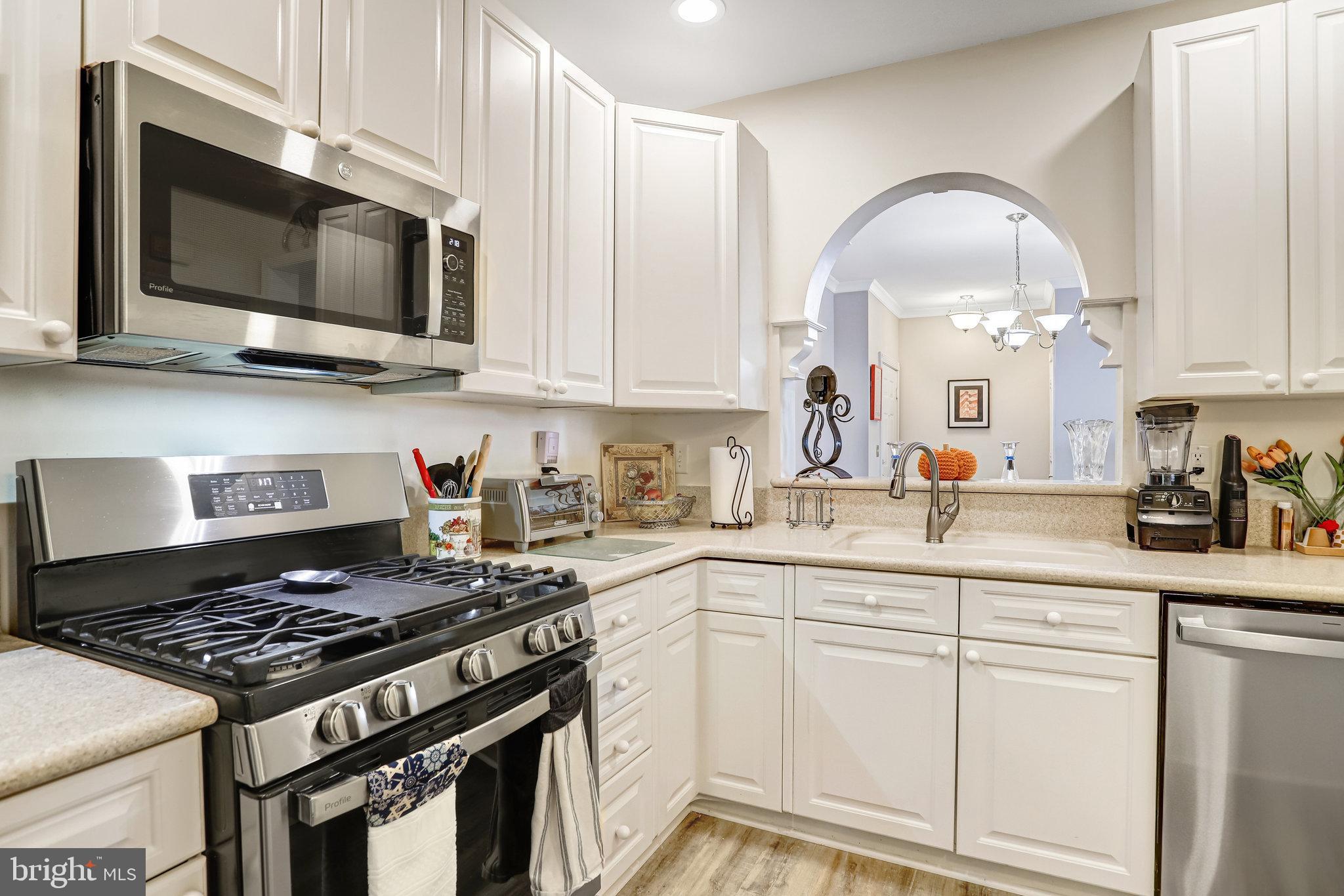 2500 Waterside Drive, Unit 303 Frederick, MD 21701 - Photo 12 of 47 a kitchen with stainless steel appliances granite countertop a stove a sink and a microwave