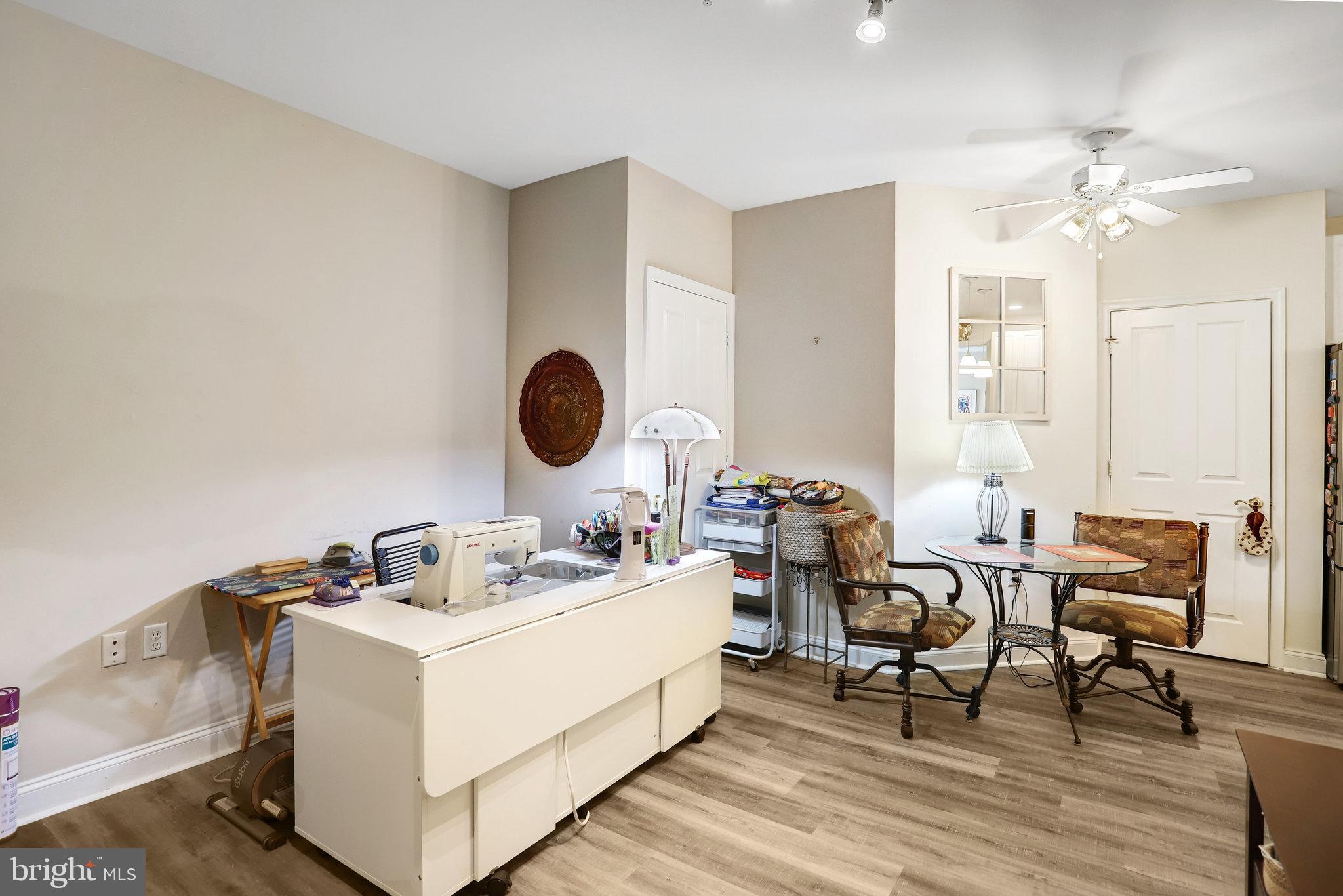 2500 Waterside Drive, Unit 303 Frederick, MD 21701 - Photo 15 of 47 a living room with furniture and wooden floor