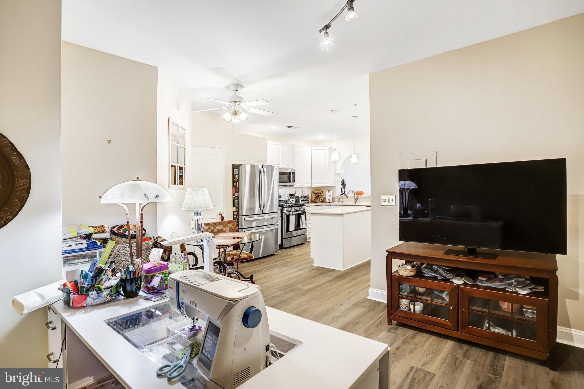 2500 Waterside Drive, Unit 303 Frederick, MD 21701 - Photo 16 of 47 a living room with furniture and a flat screen tv