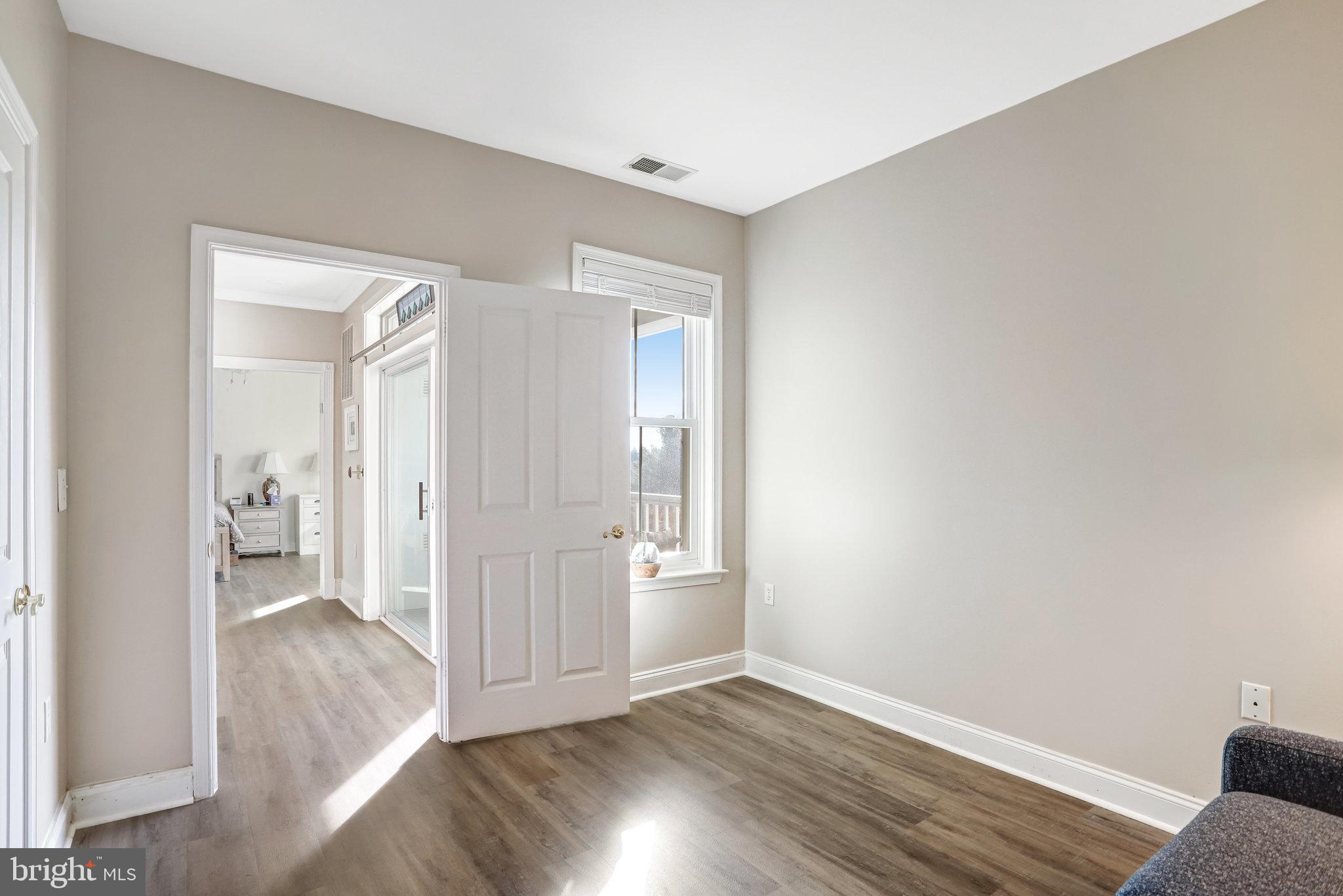 2500 Waterside Drive, Unit 303 Frederick, MD 21701 - Photo 20 of 47 a view of an empty room and wooden floor