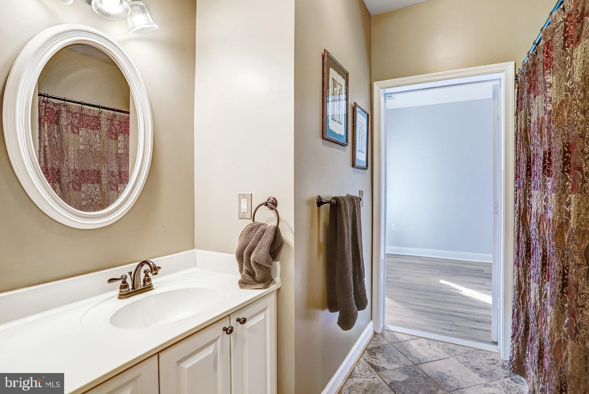 2500 Waterside Drive, Unit 303 Frederick, MD 21701 - Photo 21 of 47 a bathroom with a sink and a mirror