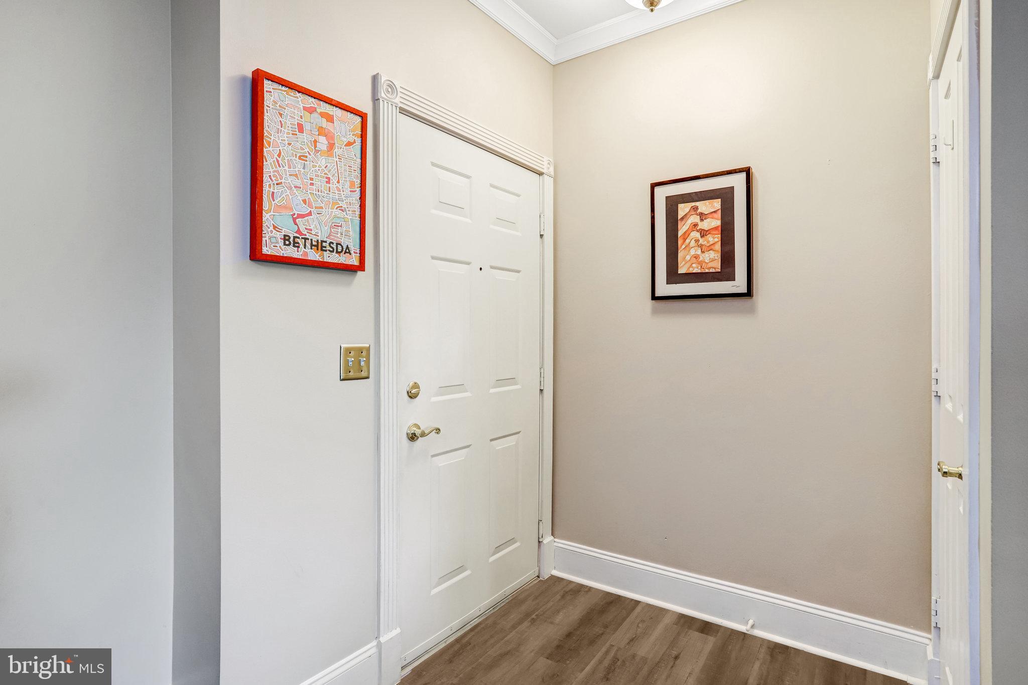 2500 Waterside Drive, Unit 303 Frederick, MD 21701 - Photo 3 of 47 a view of a hallway with wooden floor