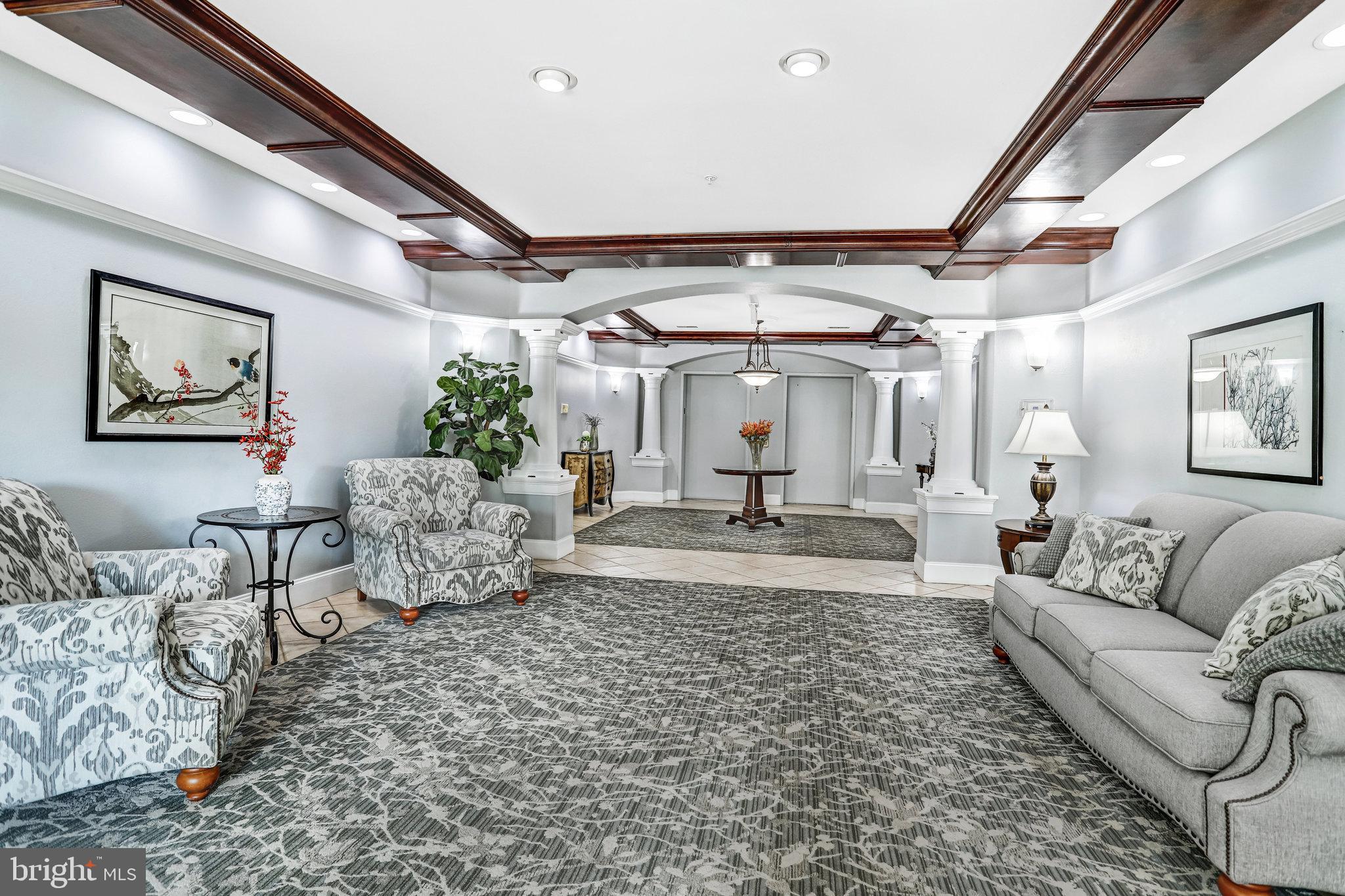 2500 Waterside Drive, Unit 303 Frederick, MD 21701 - Photo 30 of 47 a living room with furniture and a chandelier