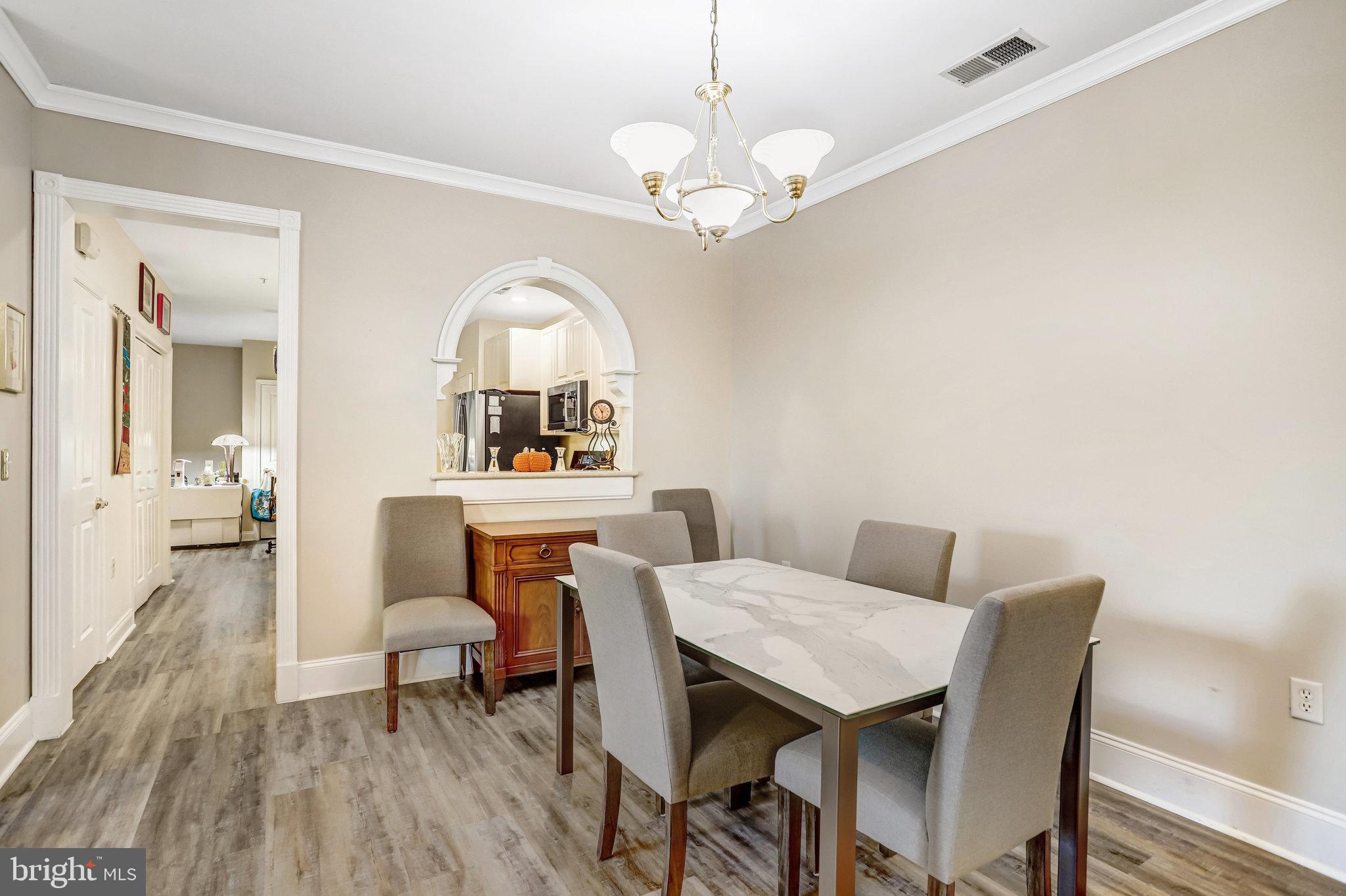 2500 Waterside Drive, Unit 303 Frederick, MD 21701 - Photo 5 of 47 a view of a dining room with furniture and wooden floor