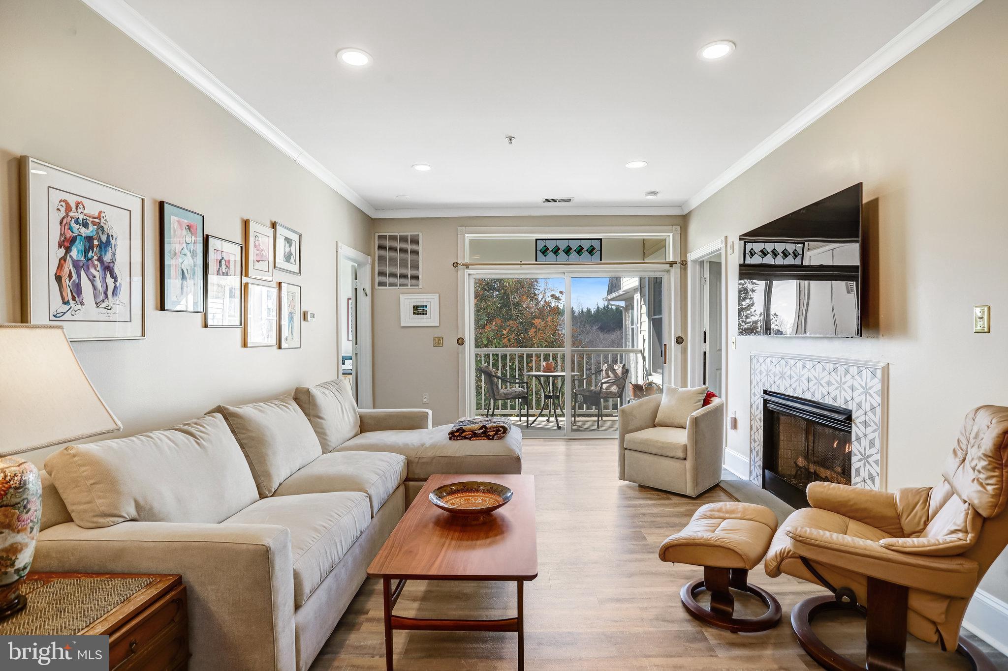 2500 Waterside Drive, Unit 303 Frederick, MD 21701 - Photo 6 of 47 a living room with furniture or couch and a fireplace