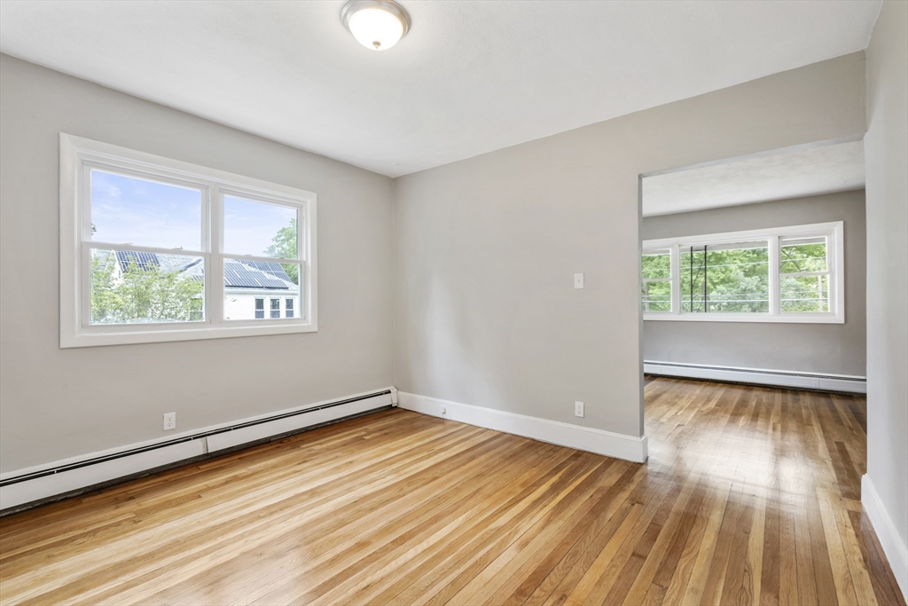 26 Riverside Drive Dedham, MA 02026 - Photo 12 of 35 a view of empty room with wooden floor and fan