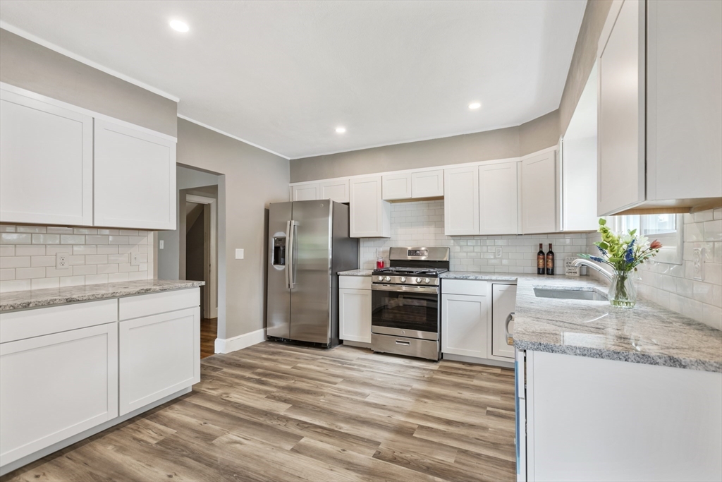 26 Riverside Drive Dedham, MA 02026 - Photo 14 of 35 a kitchen with stainless steel appliances granite countertop a refrigerator sink and stove