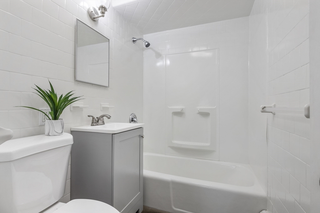 26 Riverside Drive Dedham, MA 02026 - Photo 16 of 35 a bathroom with a sink toilet and a bathtub