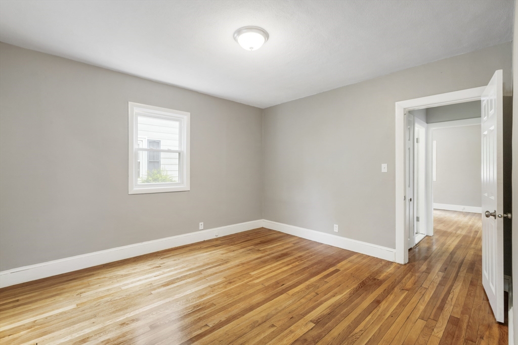 26 Riverside Drive Dedham, MA 02026 - Photo 17 of 35 a view of empty room with wooden floor