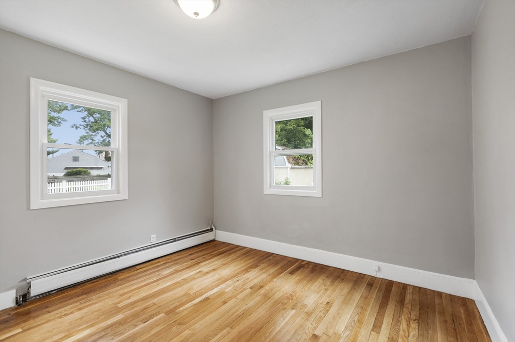 26 Riverside Drive Dedham, MA 02026 - Photo 19 of 35 a view of empty room with wooden floor and fan