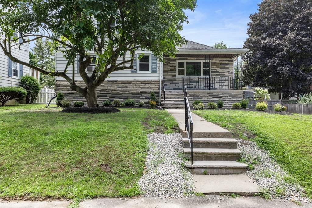 26 Riverside Drive Dedham, MA 02026 - Photo 2 of 35 a front view of a house with a yard