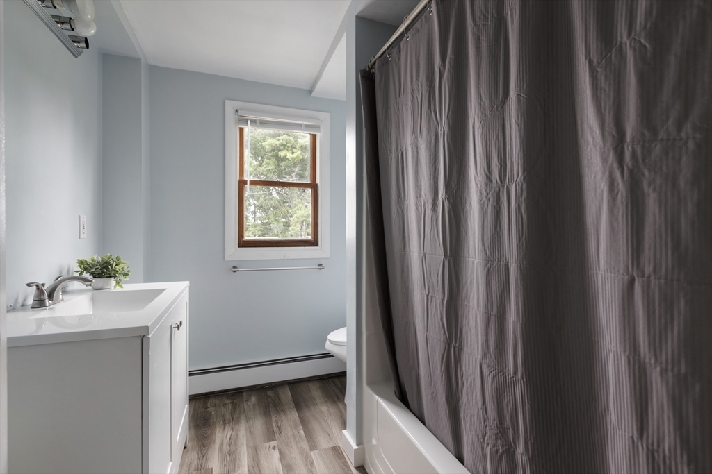 26 Riverside Drive Dedham, MA 02026 - Photo 21 of 35 a bathroom with a sink mirror and window
