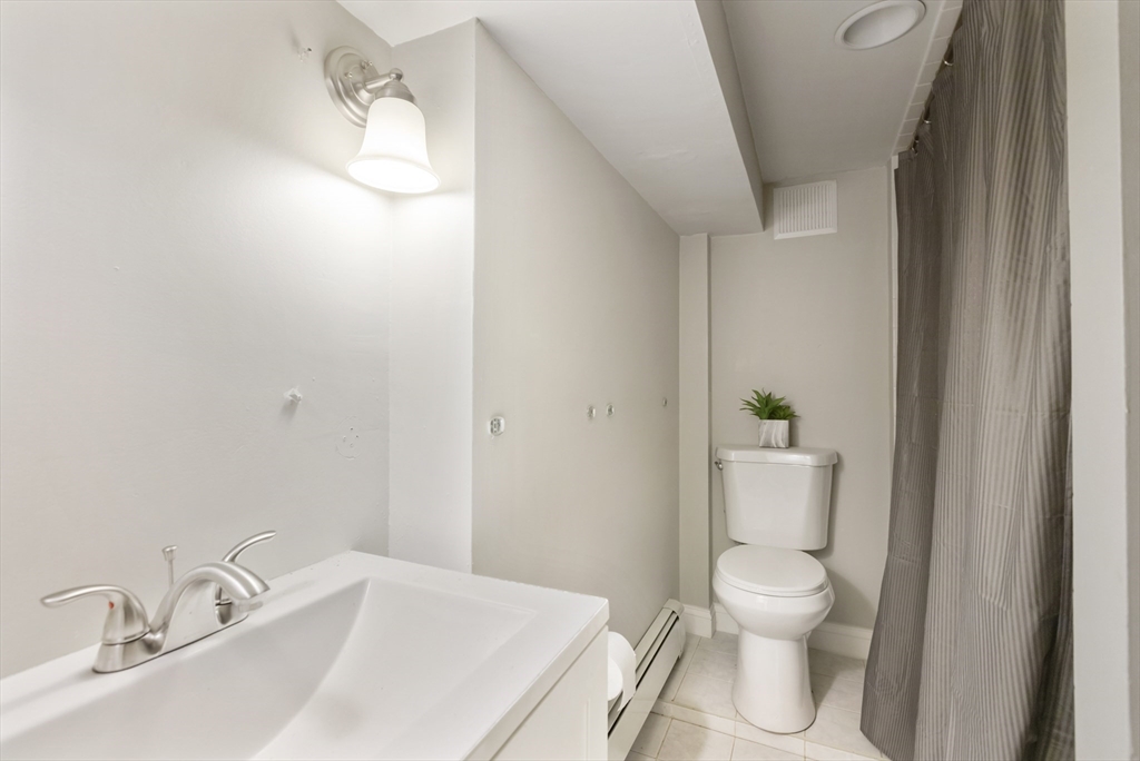 26 Riverside Drive Dedham, MA 02026 - Photo 29 of 35 a white toilet sitting next to a bathroom sink