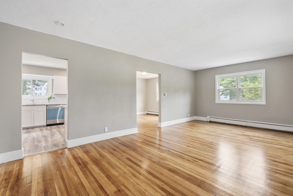 26 Riverside Drive Dedham, MA 02026 - Photo 8 of 35 an empty room with wooden floor and windows