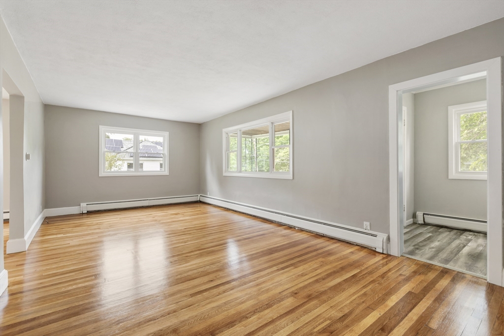 26 Riverside Drive Dedham, MA 02026 - Photo 9 of 35 a view of an empty room with wooden floor and a window