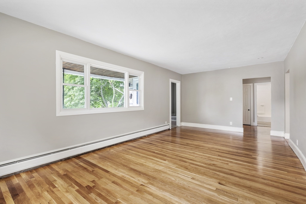 26 Riverside Drive Dedham, MA 02026 - Photo 10 of 35 a view of an empty room with wooden floor and a window