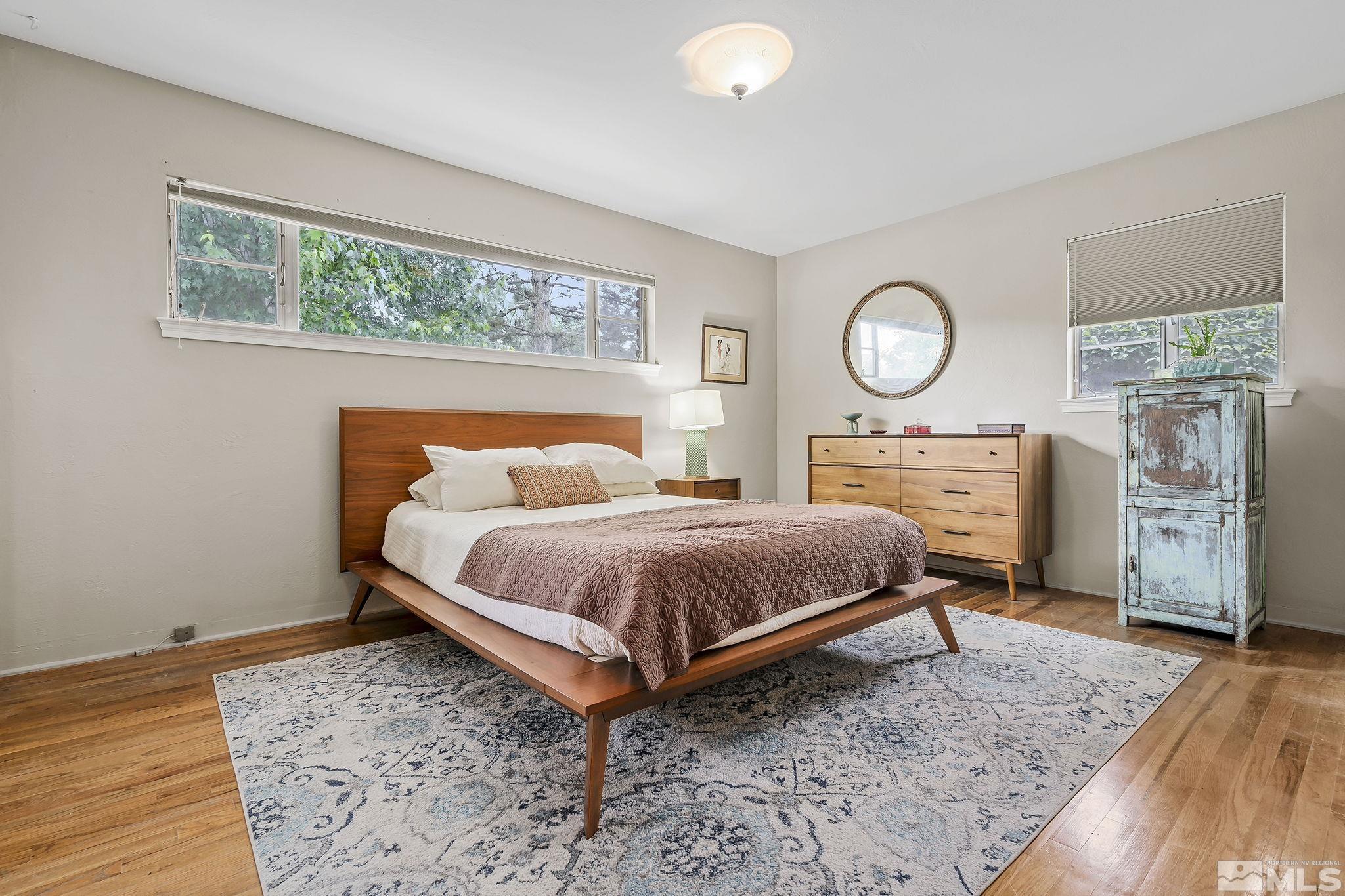 620 Cardinal Way Reno, NV 89509 - Photo 10 of 18 a bedroom with a bed and wooden floor