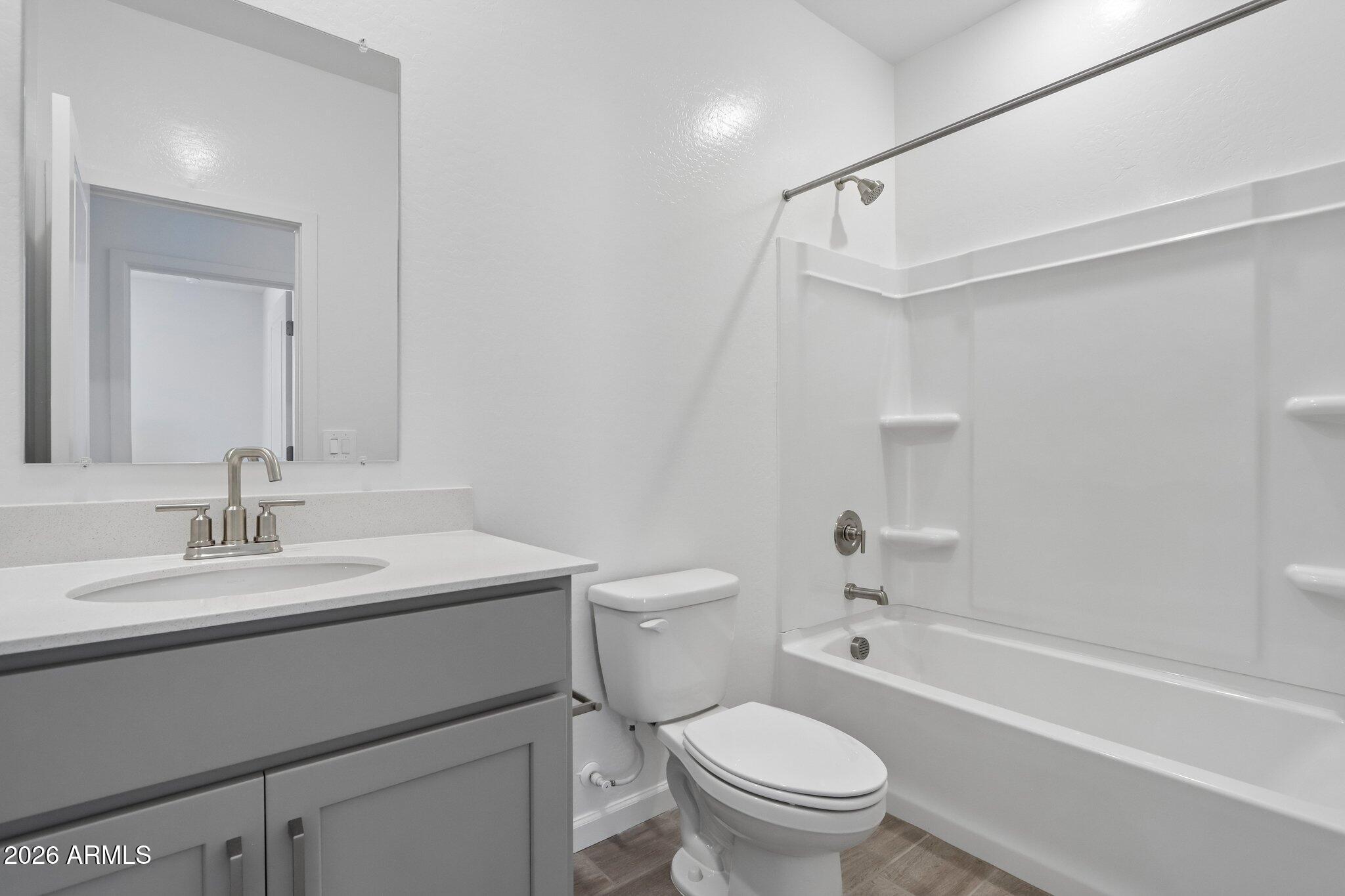 9544 West Gaby Road Tolleson, AZ 85353 - Photo 25 of 43 a bathroom with a sink a toilet and a bathtub