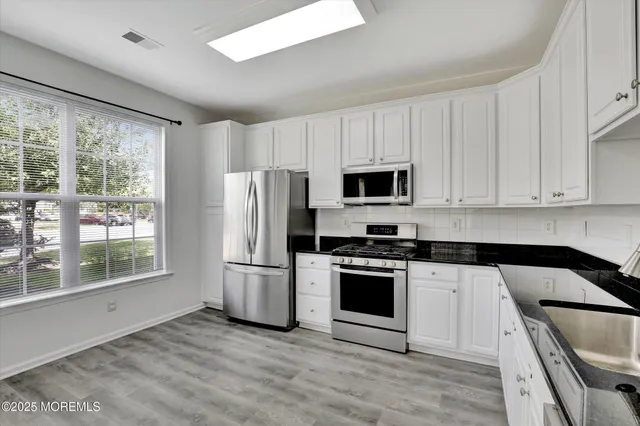 a kitchen with appliances a sink and a counter top space