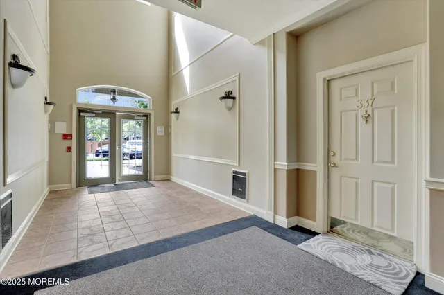 an empty room with windows and entrance