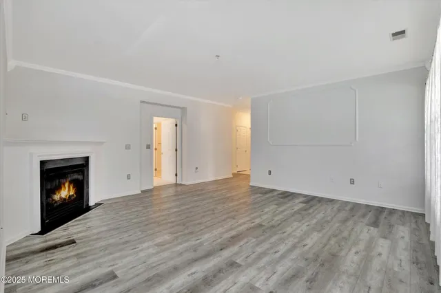 a view of an empty room with fire place and a fireplace
