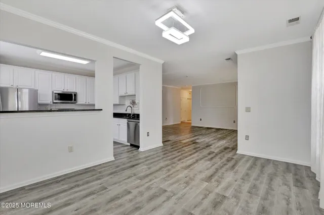 a view of kitchen with wooden floor and window