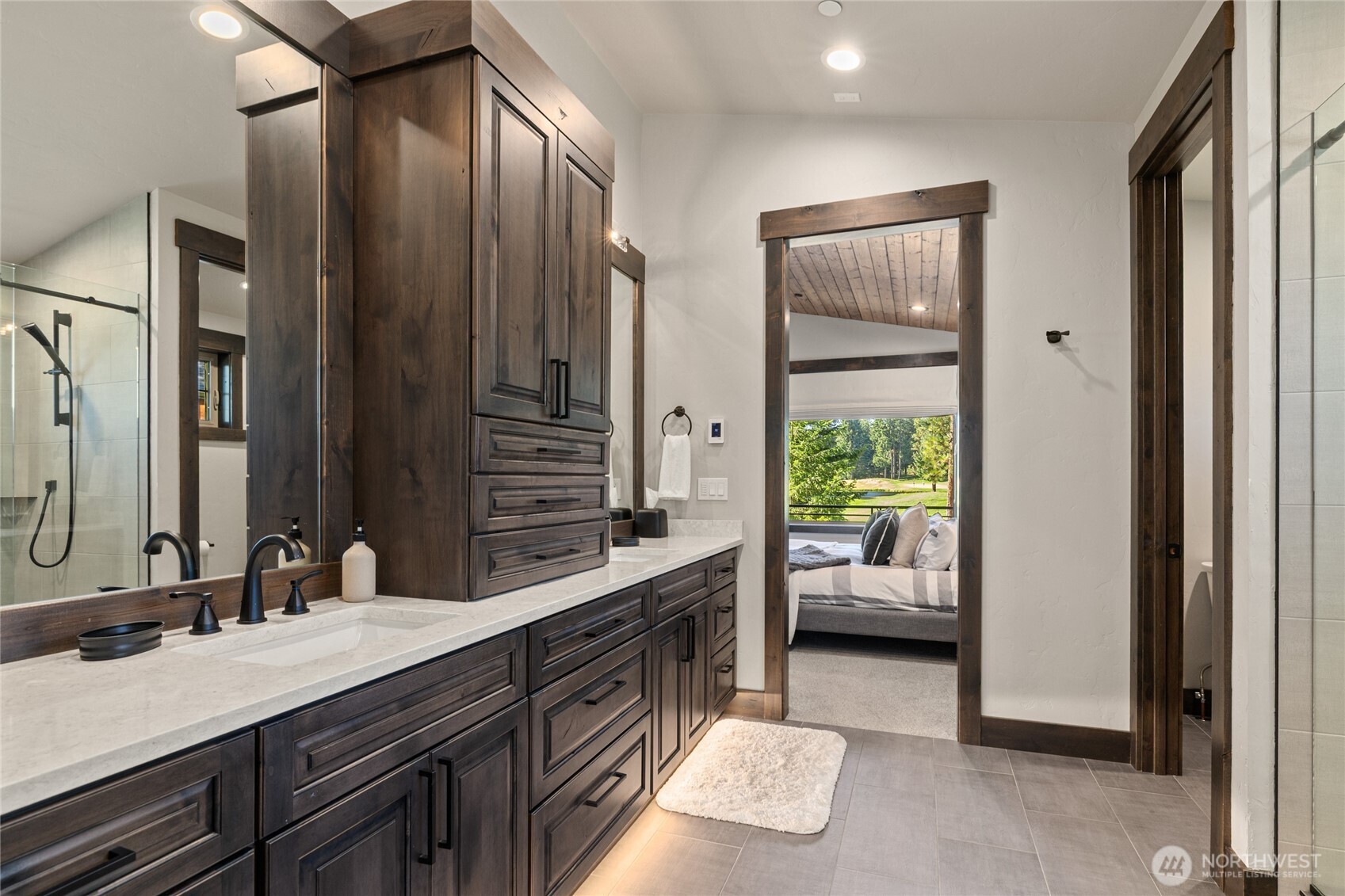 890 Larkspur Loop Cle Elum, WA 98922 - Photo 20 of 40 a en suite bathroom with a double vanity sink a large mirror and a shower