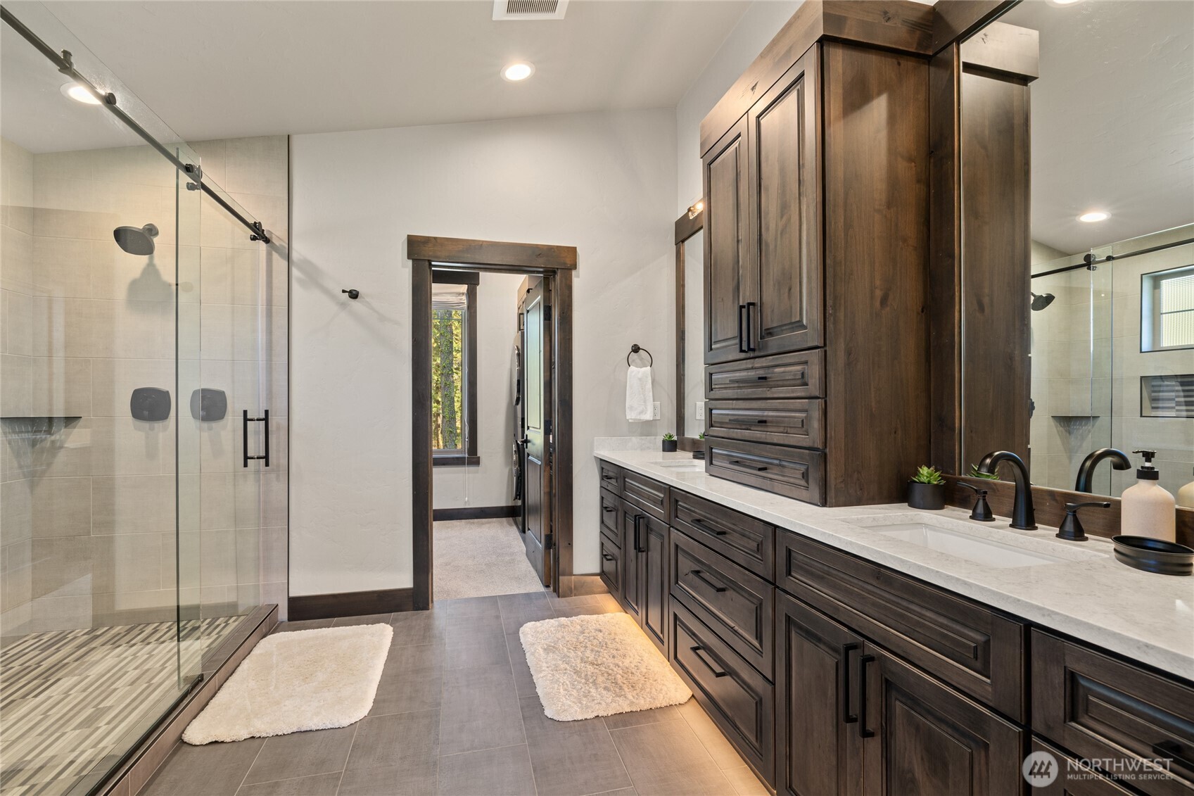 890 Larkspur Loop Cle Elum, WA 98922 - Photo 21 of 40 a spacious bathroom with a double vanity sink a mirror and a shower