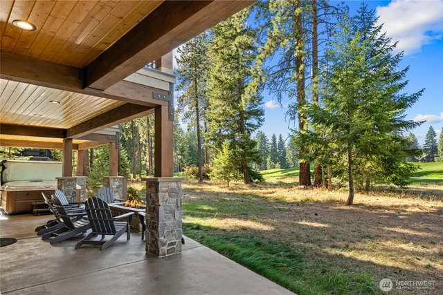 a view of a patio with table and chairs and floor to ceiling window with wooden fence